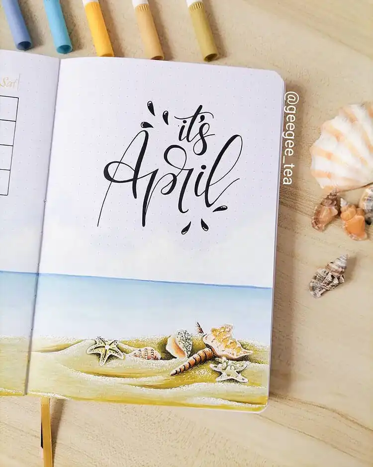 A fun and unique April bullet journal cover page featuring a serene beach scene with seashells.