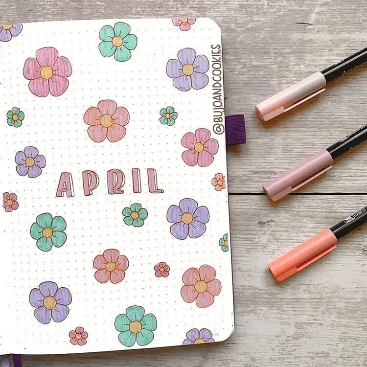 An April bullet journal cover page filled with various spring flowers, easy to recreate for beginners.