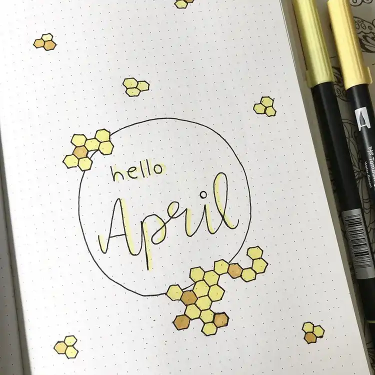 A simple April bullet journal cover page with 'Hello April' written over a honeycomb pattern.