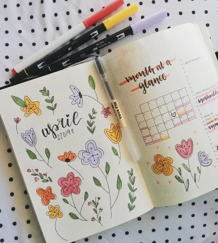 A feminine and beautiful April bullet journal cover page with a simple floral design and a pink, purple, orange, and green palette.