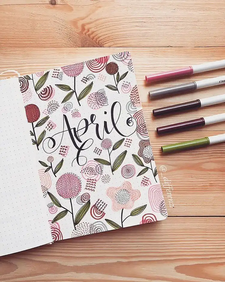 An April bullet journal cover page featuring a unique cloud drawn with interlinking bubbles and colorful raindrops.