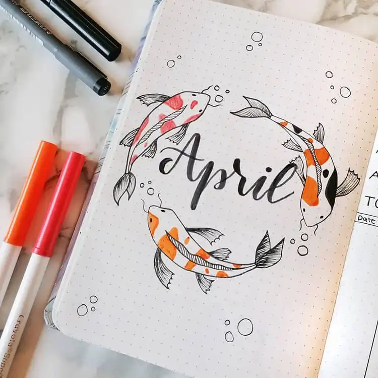An April bullet journal cover page with three graceful koi fish swimming amidst water patterns, in vibrant colors.