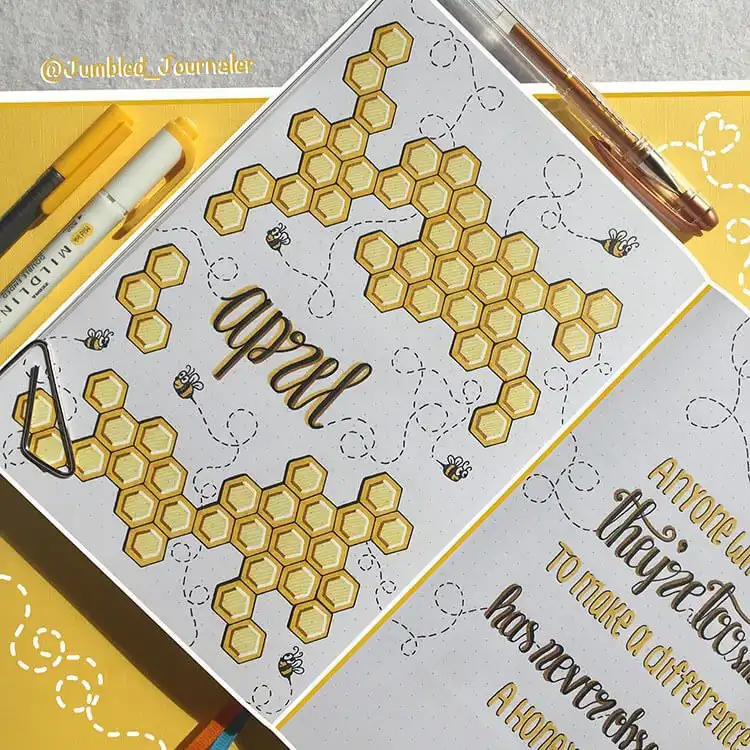 An April bullet journal cover page featuring an intricate honeycomb pattern and cute buzzing bees.