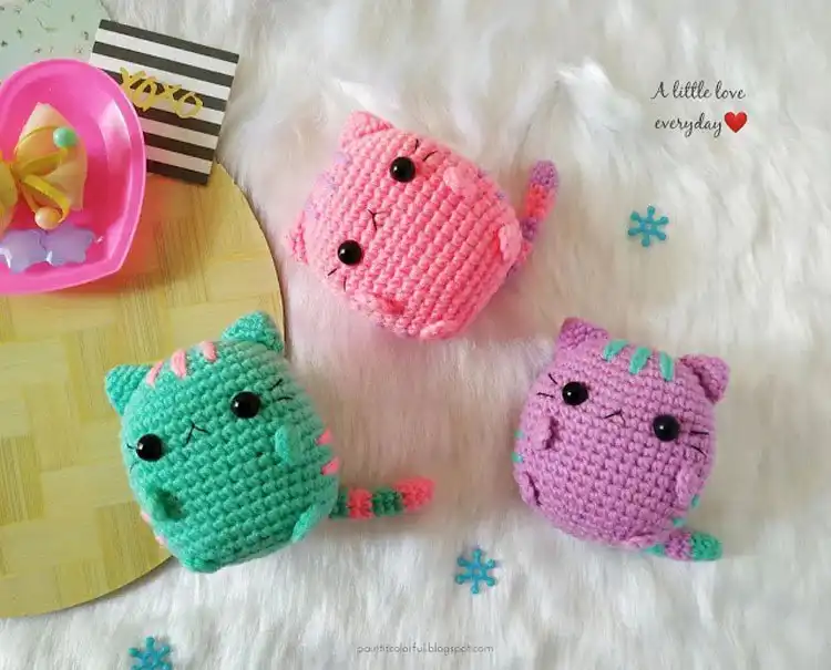 Cute Pastel Pusheen amigurumi crochet plushies in various soft colors.