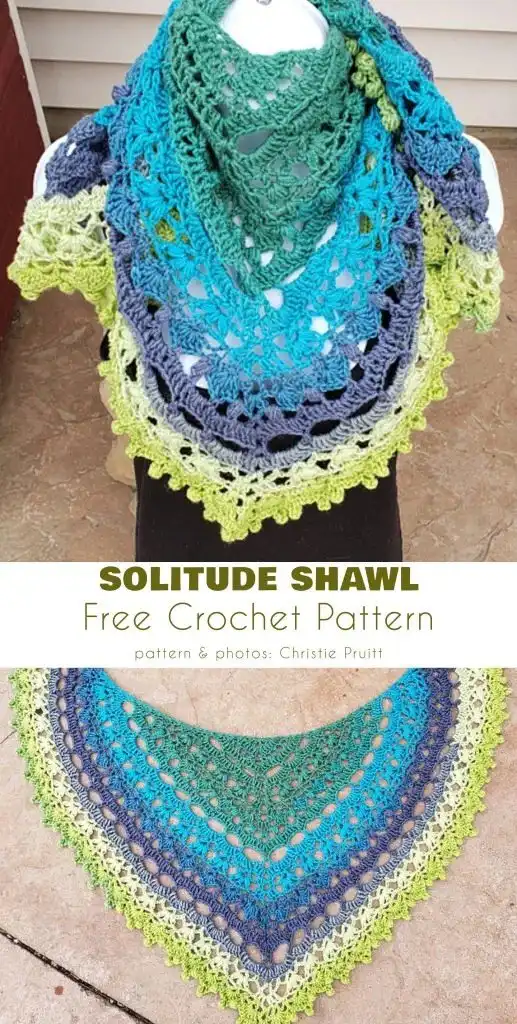 Solitude Shawl: A multicolored crescent-shaped crochet shawl in shades of green, blue, and gray, featuring intricate lace work.