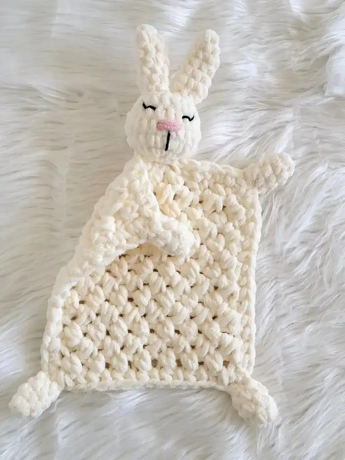 Beginner-Friendly Free Bunny Lovey Crochet Pattern Baby Gift 2 Close-up of a soft, cream-colored bunny lovey blanket portion showing textured crochet stitches.
