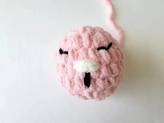 Beginner-Friendly Free Bunny Lovey Crochet Pattern Baby Gift 6 Finished crocheted bunny head with embroidered eyes, nose, and mouth, ready for attachment.