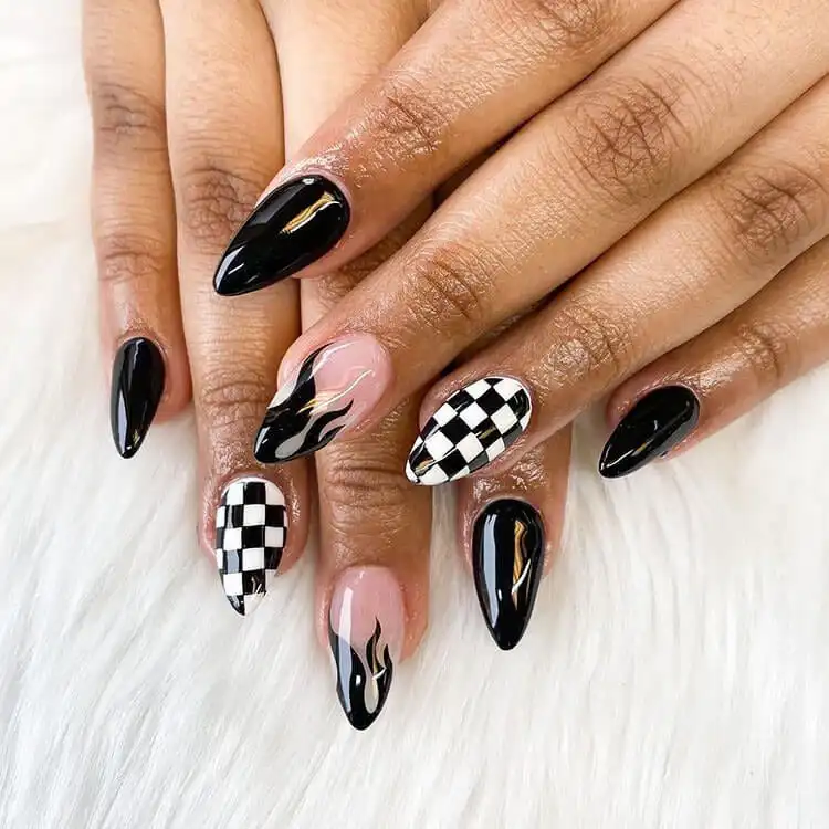 Showcase of bold black nail designs featuring intricate black flames and chic checkerboard patterns on various nail shapes.