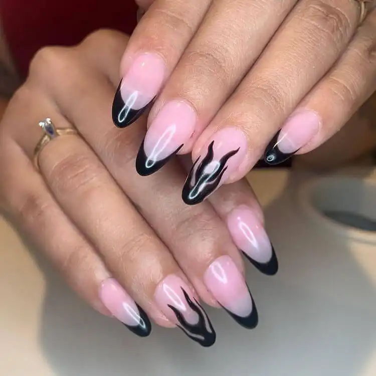 Black Nail Designs - Black Flames and Checkerboard 2 Clear nails with a sleek black French tip and a single accent nail featuring a black flame design.