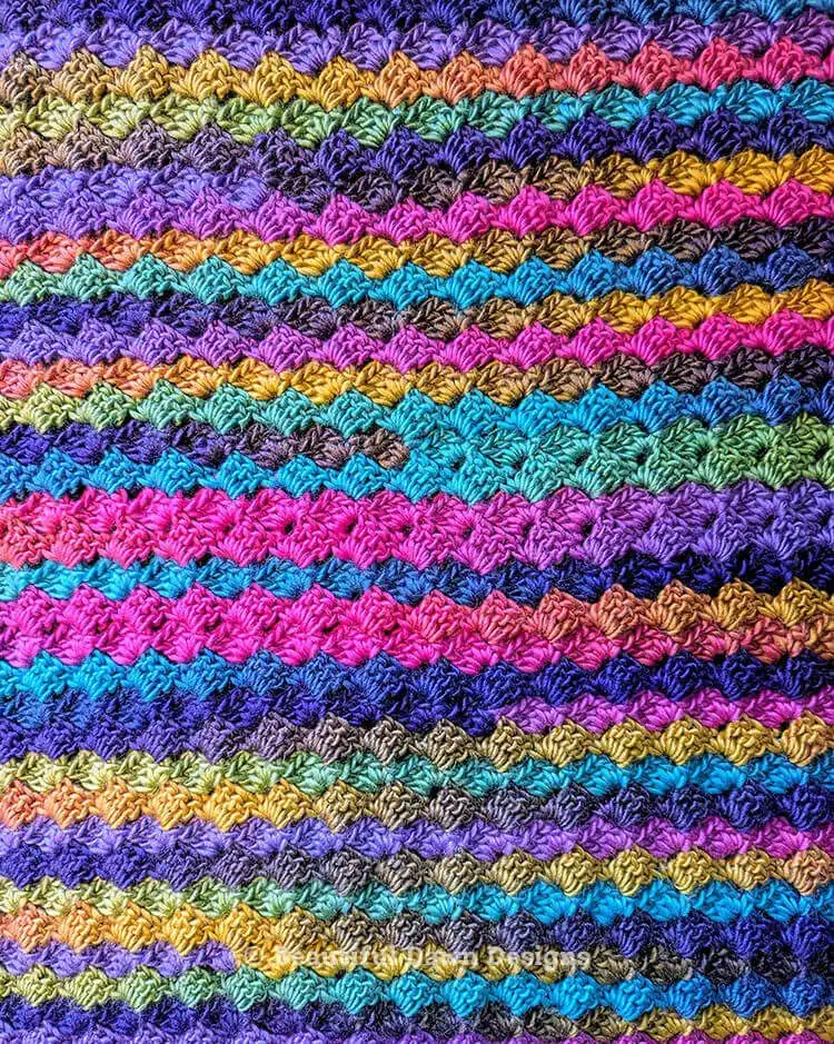 Close-up of the textured stitch pattern from the Blooming Hues Crochet Blanket, highlighting the depth and color shifts of the yarn.