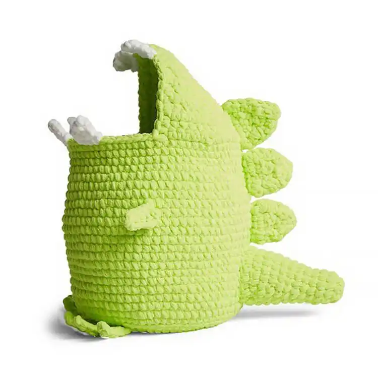Cute green crochet Dinosaur Toy Storage Basket, made with soft blanket yarn and featuring dinosaur-inspired details to organize toys.