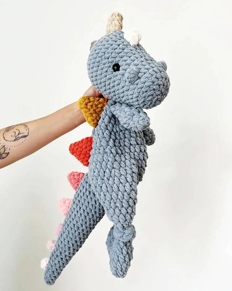 Unique crochet Bohasaurus with an unstuffed, floppy body in a light beige yarn, designed for ultimate snuggling and comfort.