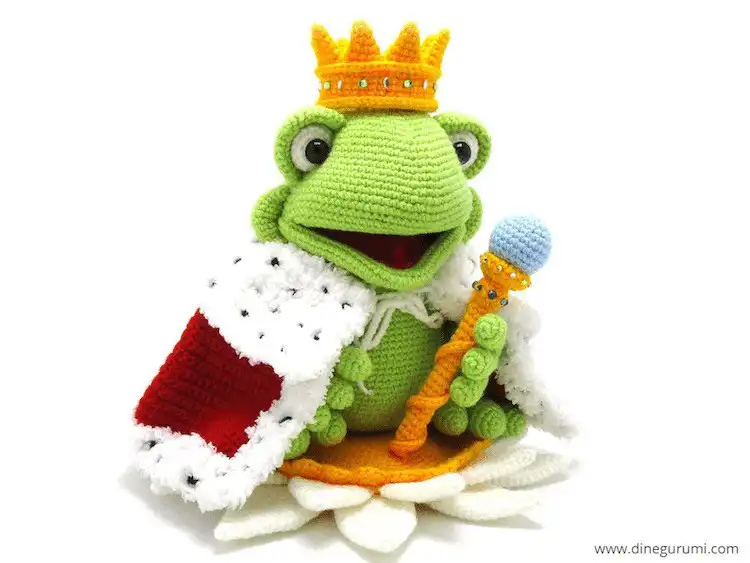 Majestic crochet King Frog amigurumi wearing an ornate golden crown, sitting regally