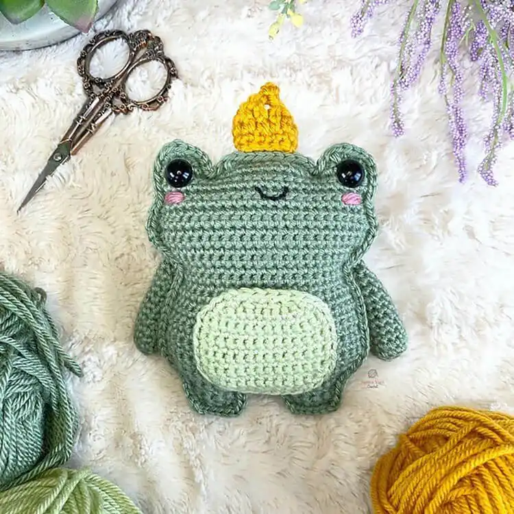 Charming crochet Royal Frog with a secret belly pocket, revealing a tiny hidden crown