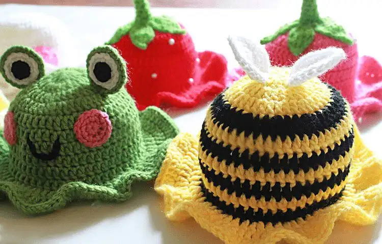 Crochet frog bucket hat in bright green with large eyes and a slightly open mouth
