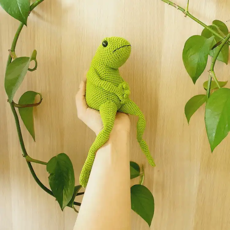 Sophisticated crochet Arthur the Frog amigurumi sitting upright with a thoughtful expression