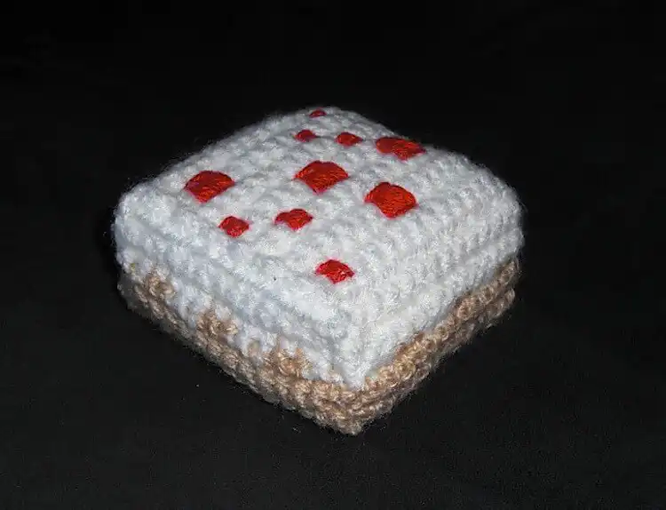 Crocheted red and brown pixelated Minecraft cake replica