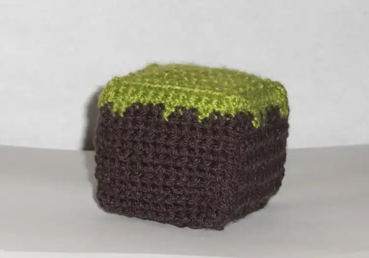 Small crocheted brown and green Minecraft dirt block cube