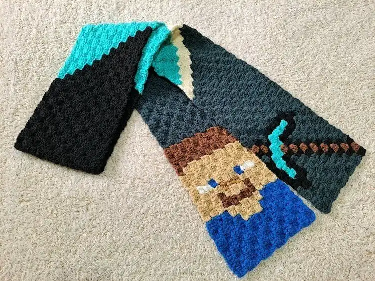Long crocheted scarf with Minecraft pixelated designs and characters
