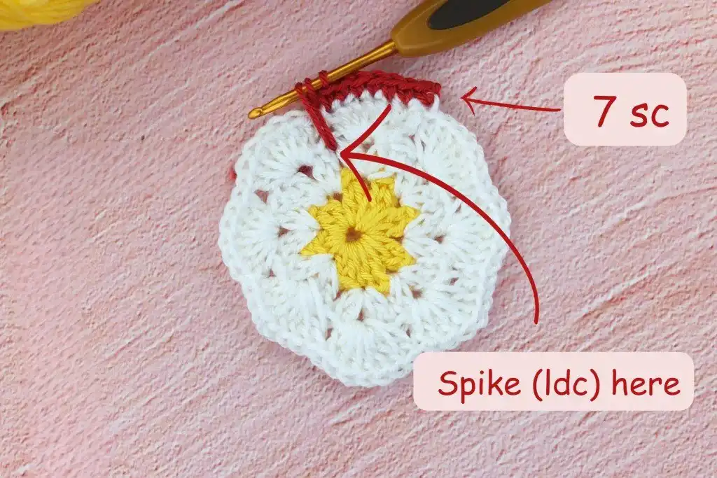 Photo tutorial of Round 3 in the African flower square crochet pattern, showing the formation of 7dc arches for each petal, adding volume and shape.