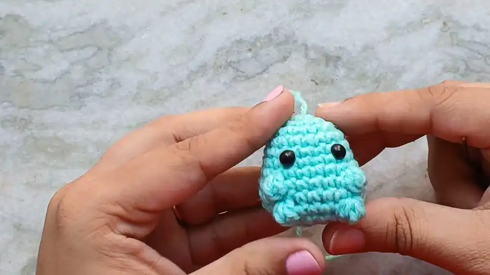 Partially crocheted body of the Crochet Baby Axolotl With Custom Gills and Bubble-Stitch Limbs, showing the initial head shape.