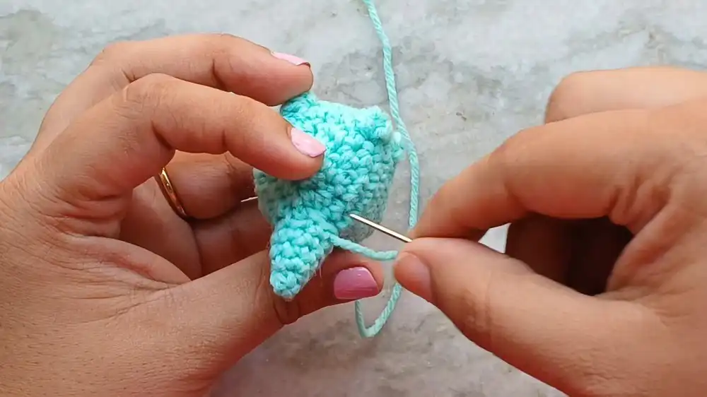 Close-up of the Crochet Baby Axolotl With Custom Gills and Bubble-Stitch Limbs showing the bubble stitch arms being formed.