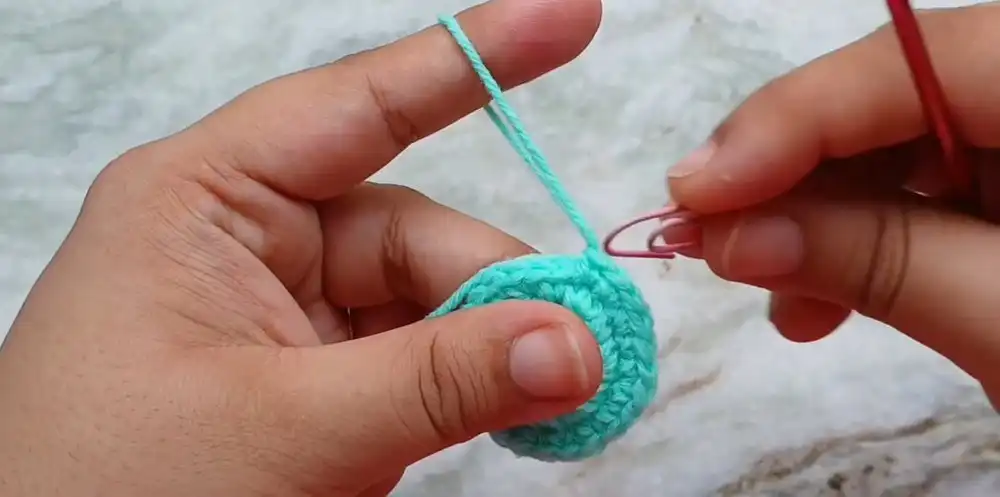 Partially crocheted jellyfish body showing the base and initial rounds of shaping.