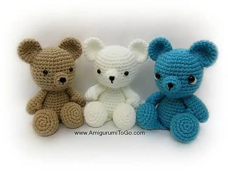 Very small, simple brown crochet teddy bear sitting upright.
