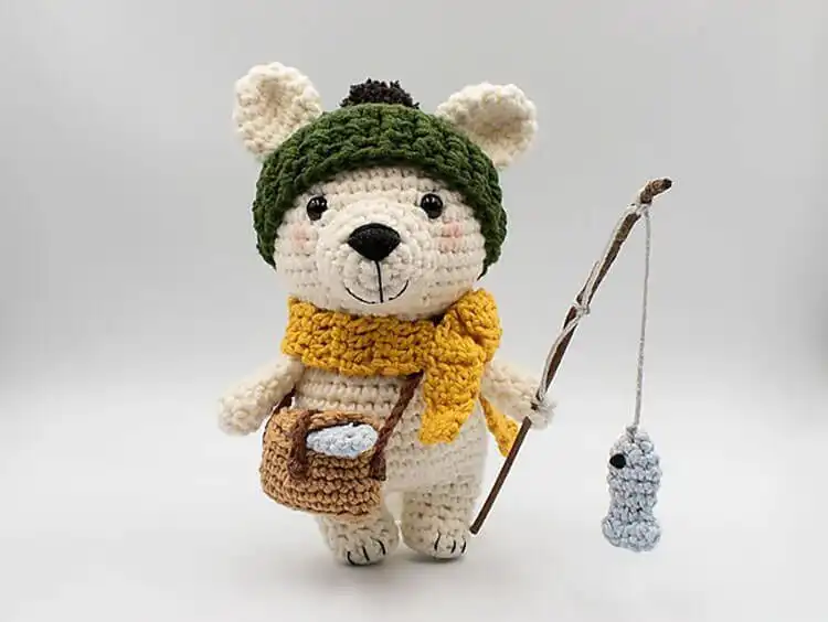 Large, soft white crochet polar bear named Bruno, sitting calmly.