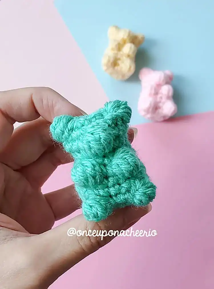 Vibrant, colorful no-sew gummy bear amigurumi in bright red and blue.