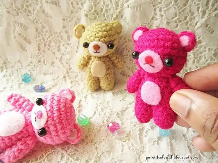 Tiny amigurumi mini teddy bear in light brown yarn, perfect for keychains.