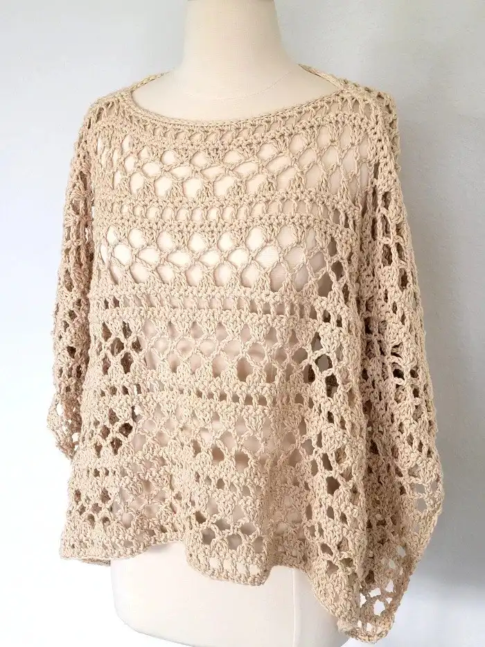Side view of the finished Crochet Lacy Summer Poncho on a mannequin, demonstrating its relaxed fit and graceful drape.