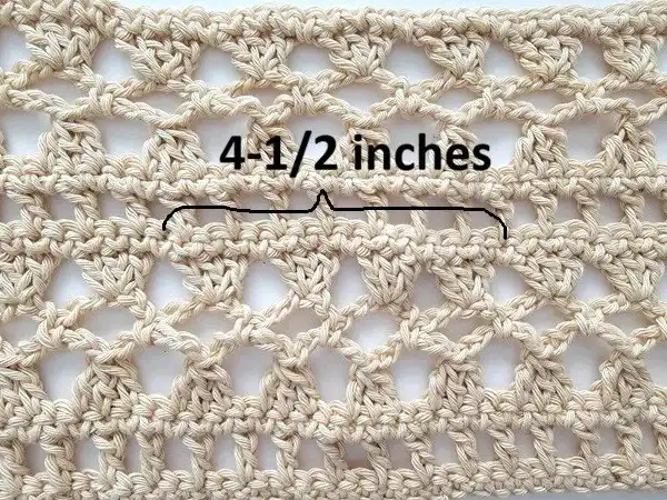 Hands measuring a crochet gauge swatch for a lacy poncho pattern, ensuring correct stitch count for the Crochet Lacy Summer Poncho.