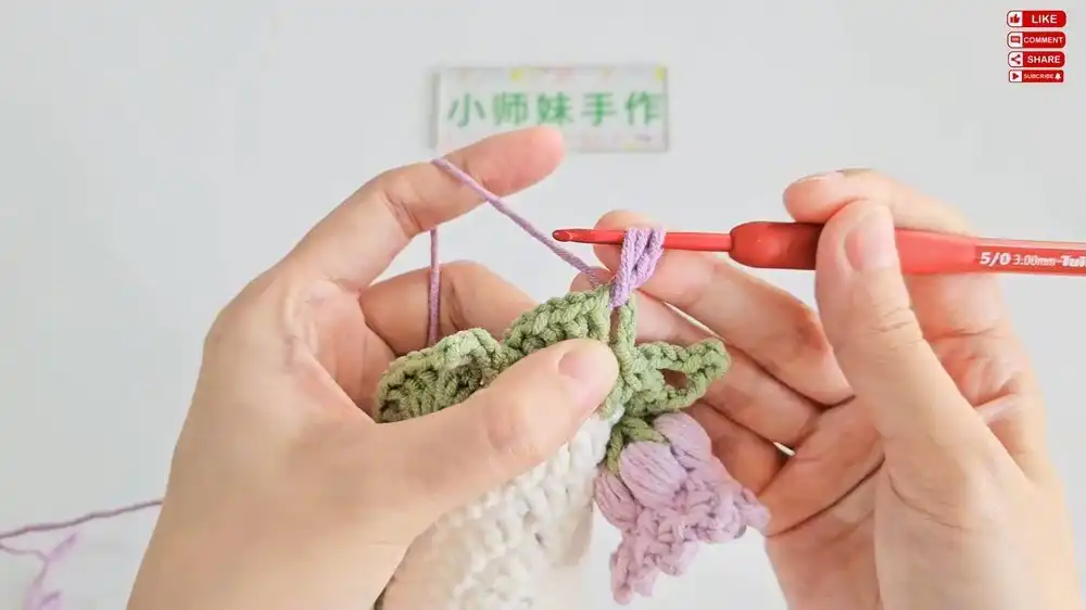Crocheting the delicate green leaf details for the Lily of the Valley Coaster, illustrating the DIY craft process.