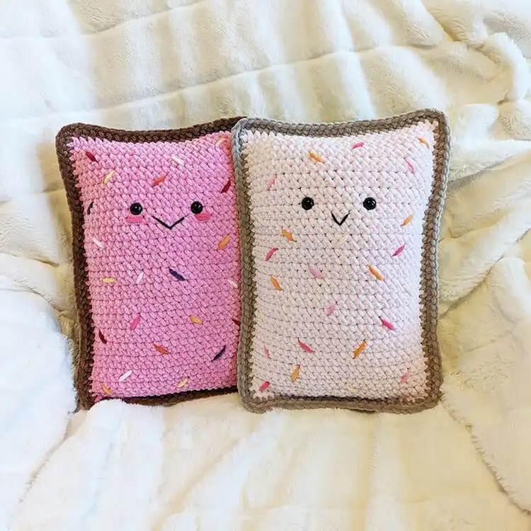 Cute crochet toaster pastry plushie with white frosting and colorful sprinkles