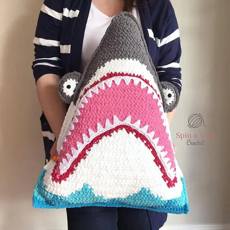 Playful crochet shark pillow with open mouth detail and felt teeth