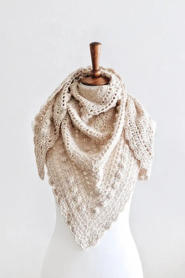 A vintage-inspired Isla Scarf in delicate lace stitches, folded to show its intricate pattern.