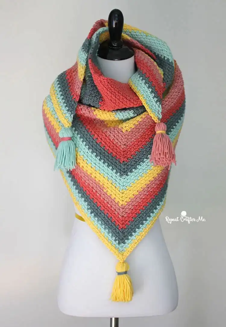 A textured Moss Stitch Shawl made from a colorful cake yarn, highlighting the dense fabric.