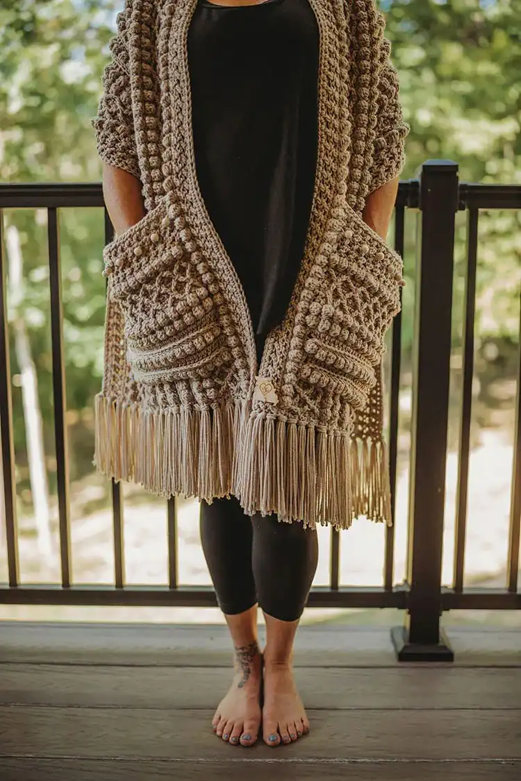A chunky Boho Beaded Pocket Scarf with long fringes and visible beads, perfect for winter.