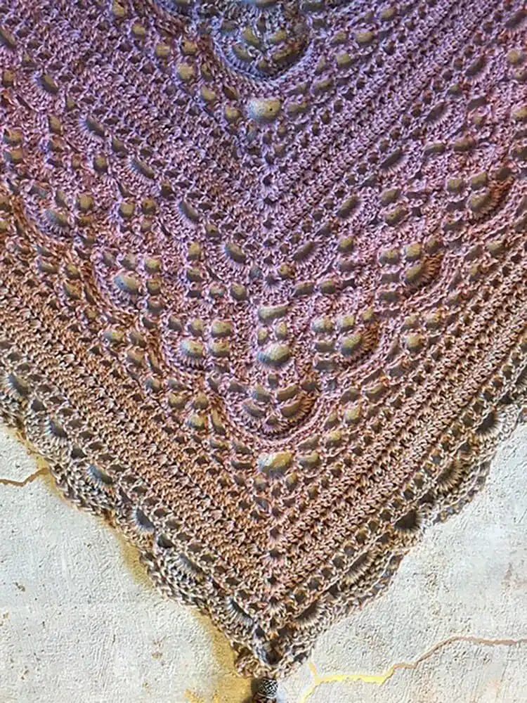 A versatile Klaziena Shawl with an intricate stitch pattern, showing options for triangular or rectangular shapes.