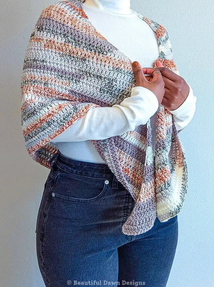 A simple Double Crochet Triangle Shawl in a solid soft blue yarn, neatly folded to show its classic texture.
