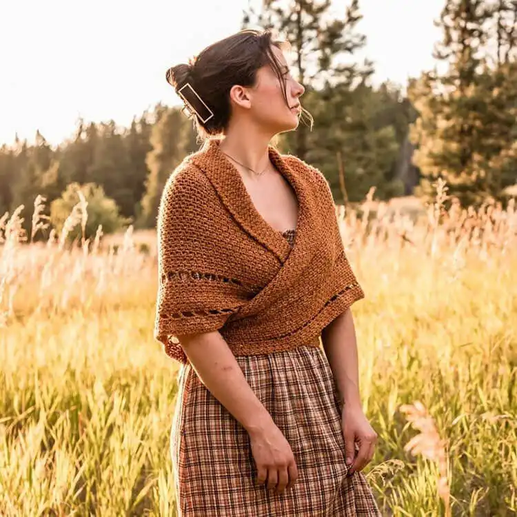 A rustic Outlander Inspired Shawl in a heathered grey wool, draped casually to showcase its historical charm and cozy texture.