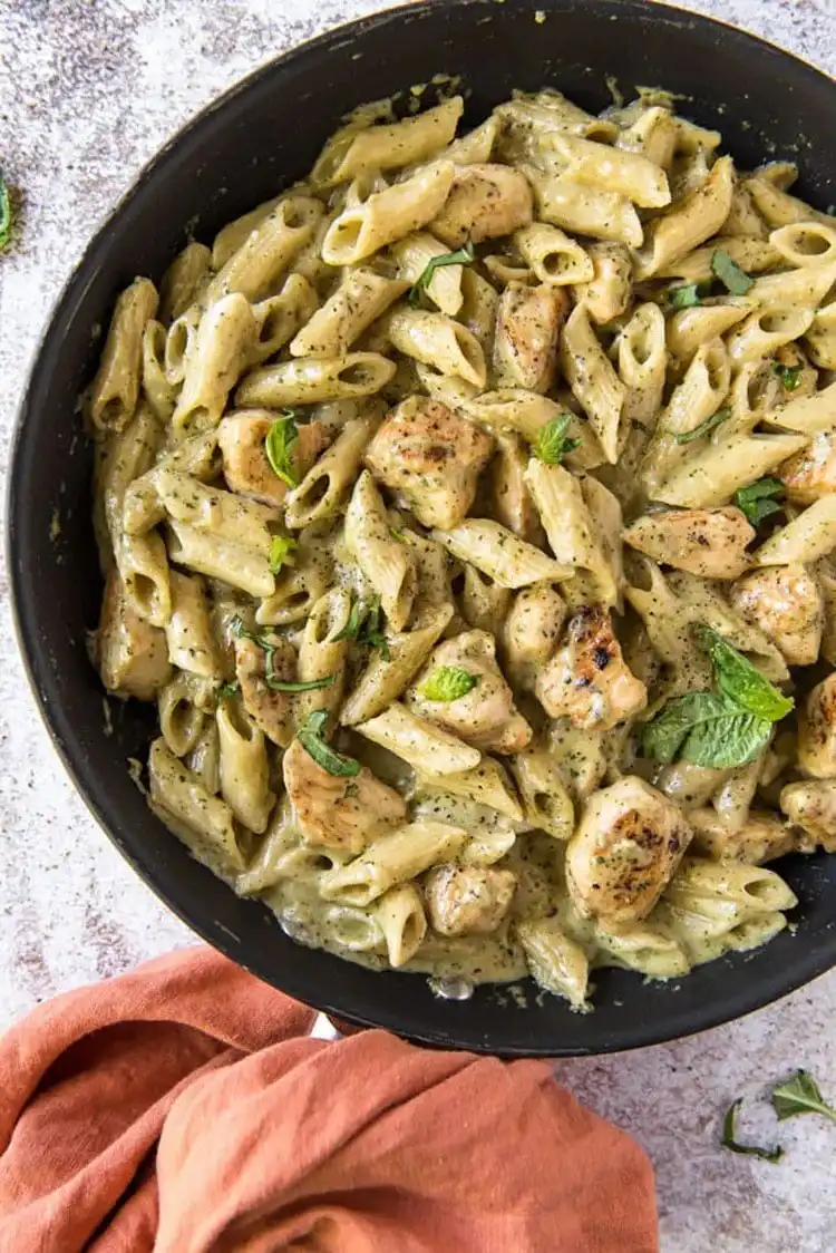 Creamy Pesto Chicken with pasta, a vibrant and quick meal, rich with pesto flavor, a fast Crockpot Chicken Nachos Recipe - Perfect Dinner Idea.