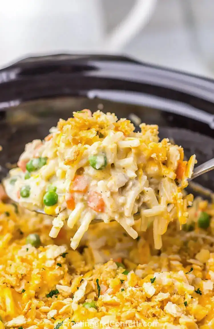 Slow Cooker Chicken Pot Pie Hash Brown Casserole, showing a creamy filling beneath a layer of cheesy hash browns, a unique Crockpot Chicken Nachos Recipe - Perfect Dinner Idea.