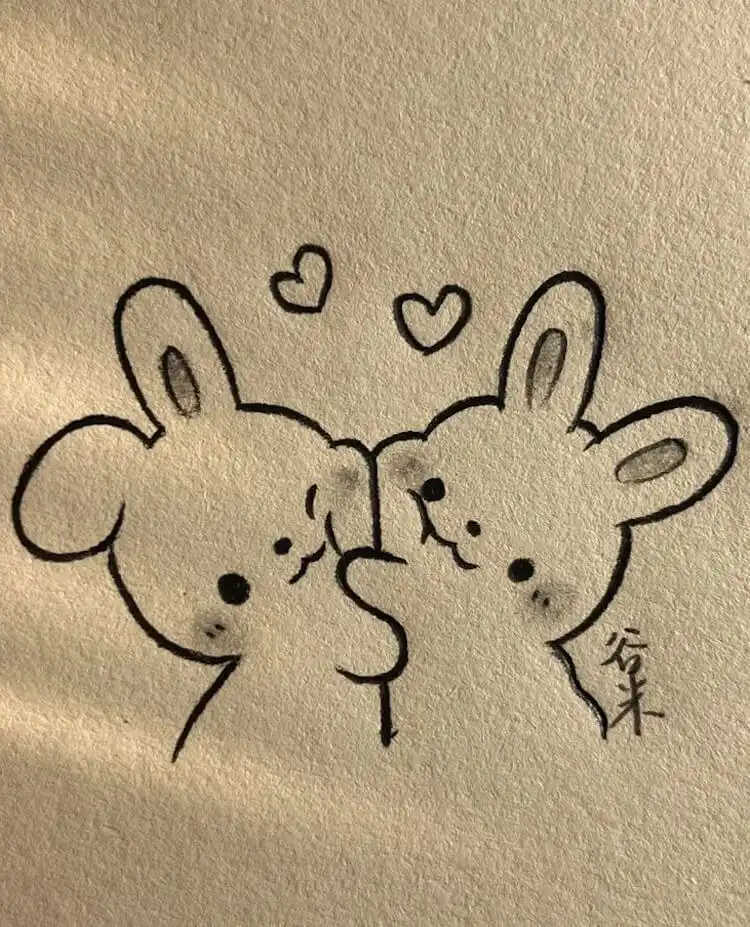 Cute Animal Drawing Idea - Cat/Kitten Holding a Strawberry 3 Two charming bunnies hugging each other tenderly, with small hearts floating around, drawn with gentle lines to express warmth and affection.
