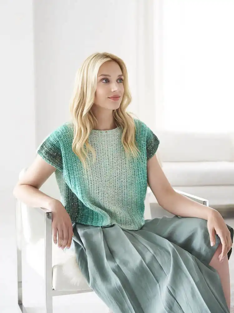 Cozy Cable Stitch Cropped Hoodie, a unique crochet top for cool summer evenings.