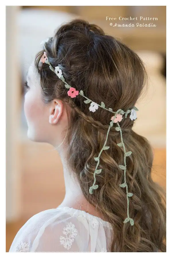 Elegant crocheted floral headband with delicate, refined flower clusters in a classic color, styled on hair.