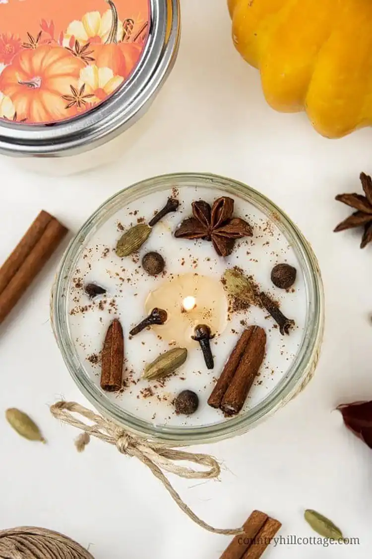 Cozy Pumpkin Spice Candle adorned with cinnamon sticks and autumn spices, perfect for fall decor
