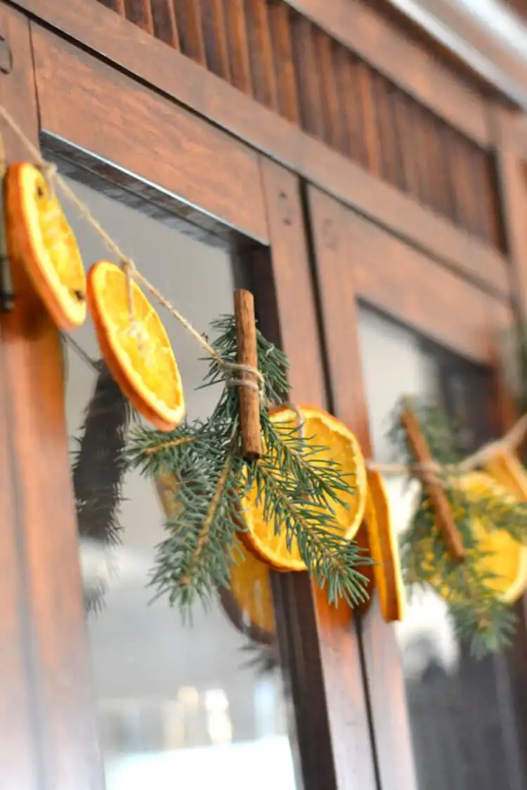 Rustic Dried Oranges and Pine Twigs garland, showcasing vibrant oranges against dark green pine needles for holiday home decor.