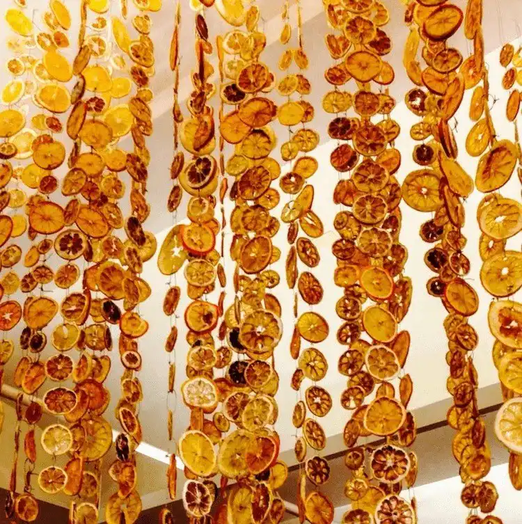 Contents of a DIY Orange Garland Kit, including pre-dried slices, spices, and twine, for convenient holiday craft projects.